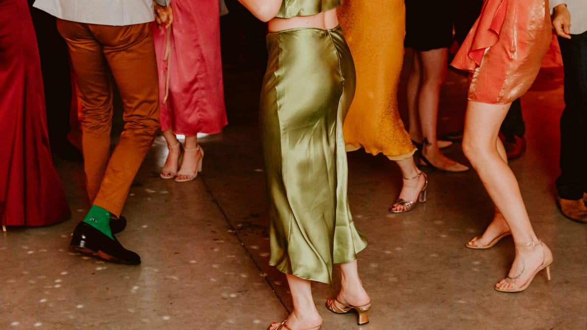 Wedding guests in polished outfits showing midi dresses and colorful separates