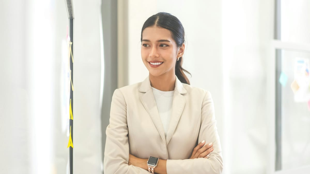 A neutral blazer over a simple top demonstrates how professional colors frame rather than distract