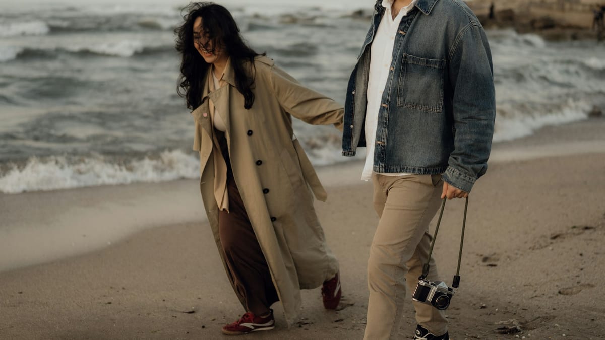 A couple walking together in considered everyday outfits, illustrating what dressing like yourself looks like in motion